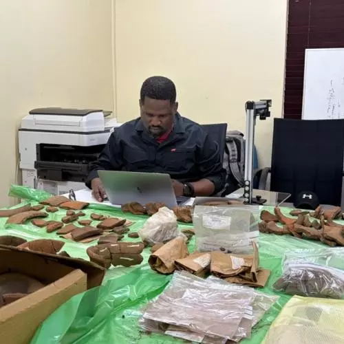Russell Kapumha recording pottery sherds at the University of Venda
