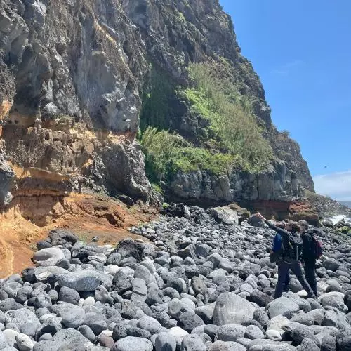 the team walk on the rocky beach