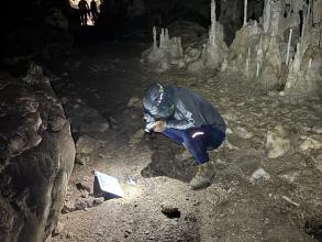 Gary Zuniga photographing archaeological finds in Monkey Bay National Park. 