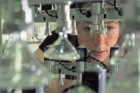 woman in safety goggles in a lab
